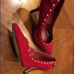Red heels with studs and bow in back. Never worn.